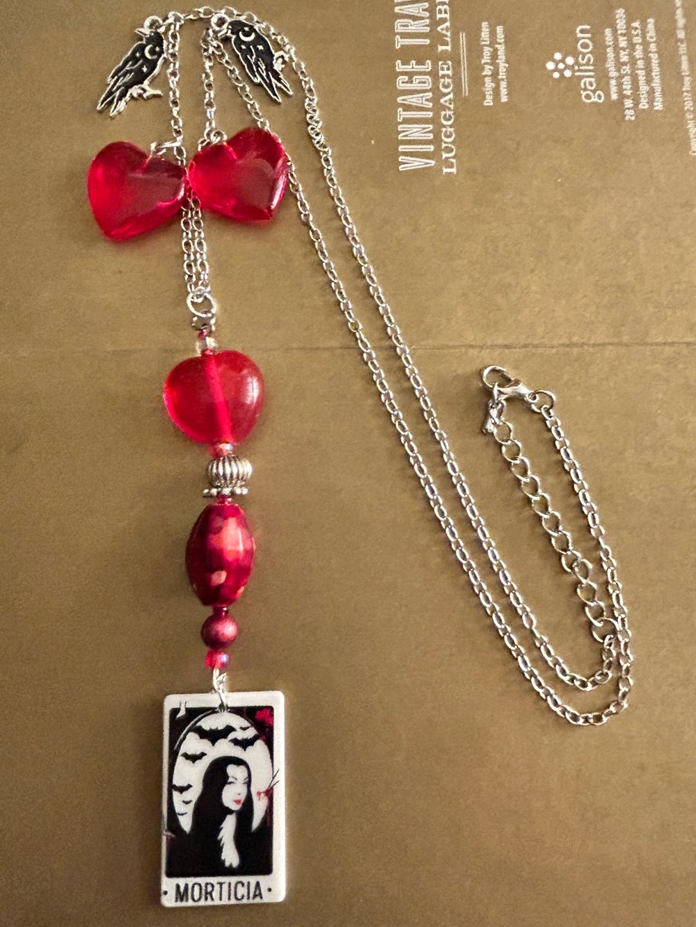 NWOT Charms necklace Morticia Addams portrait, red glass hearts, crows, beads